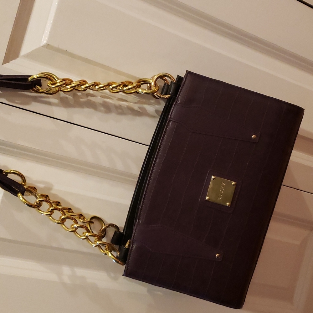 A royal purple Miche handbag with gold chain straps.